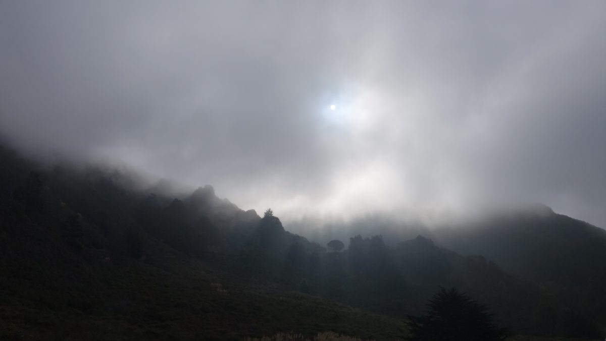 Cycling tour - Vancouver to LA - Sun through clouds, fog, mountain